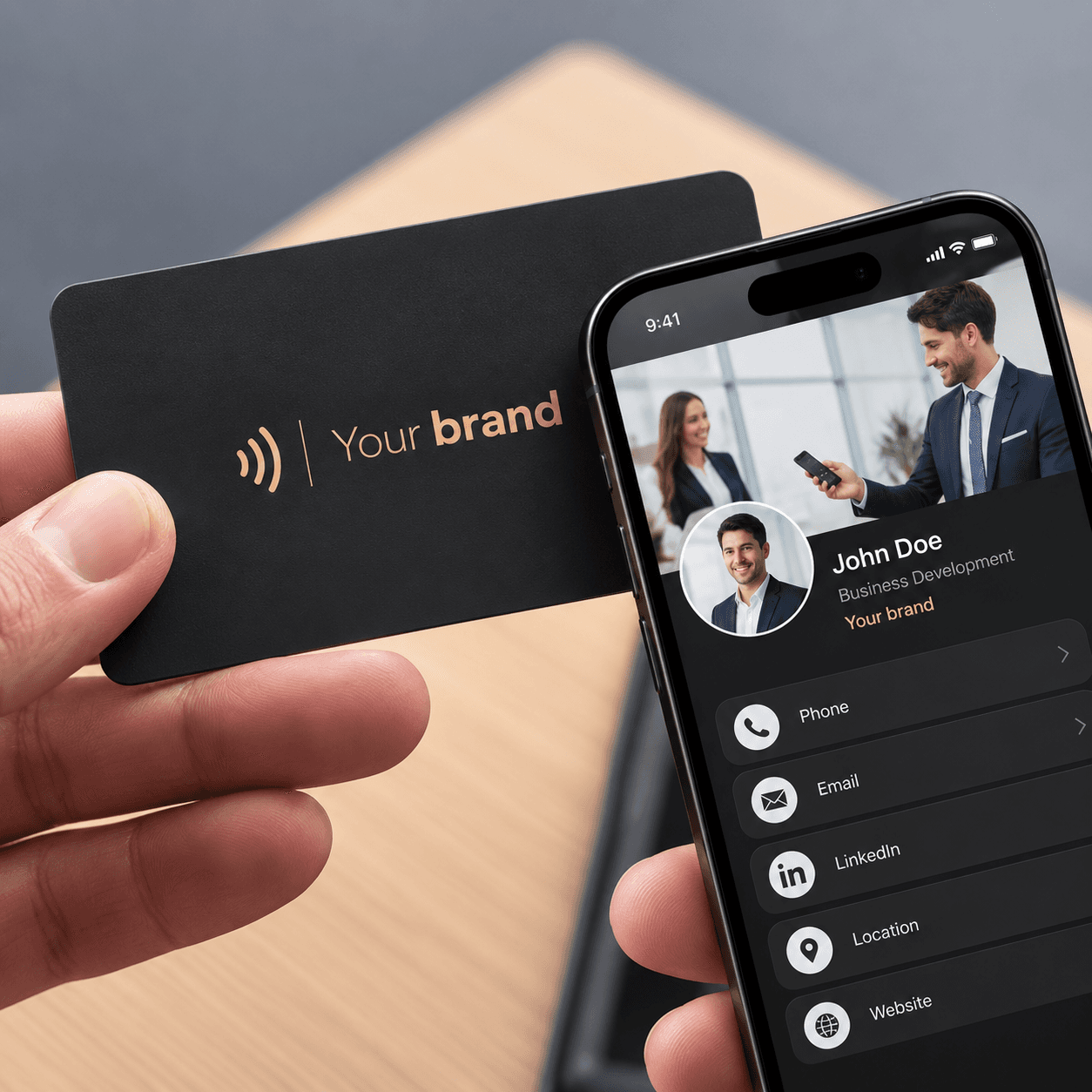 A hand holding a matte black NFC business card next to a phone showing the profile it opens